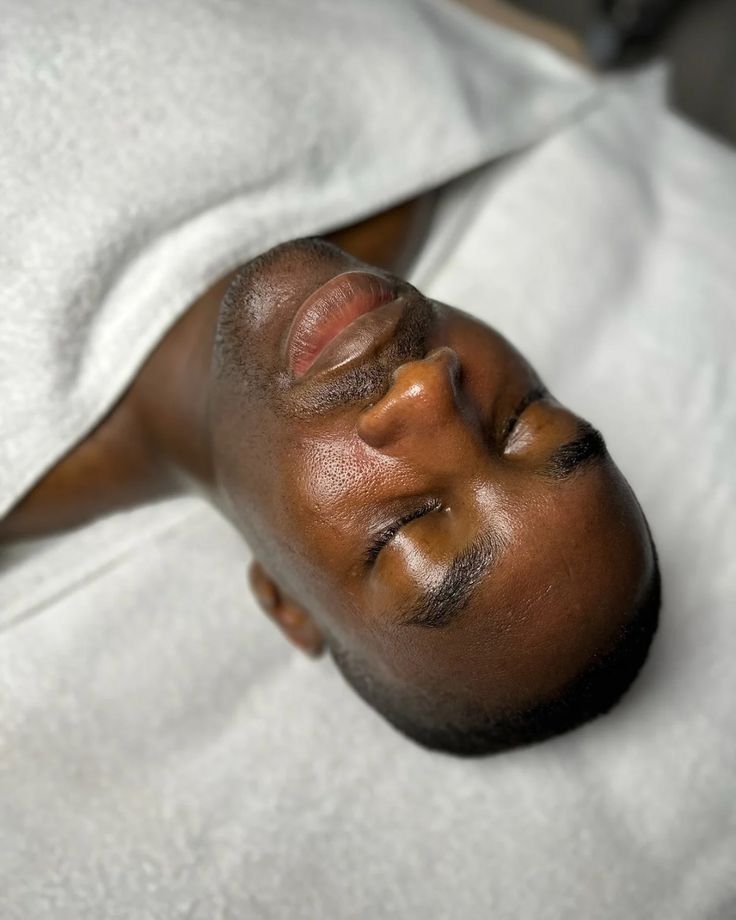 Client deeply relaxed during a facial massage